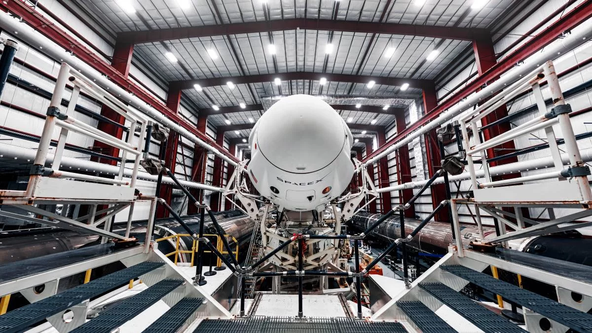 Space launch preparation. Spaceship SpaceX Crew Dragon, atop the Falcon 9 rocket, inside the hangar , just before rollout to the launchpad. Elements of this image furnished by NASA - stock photo