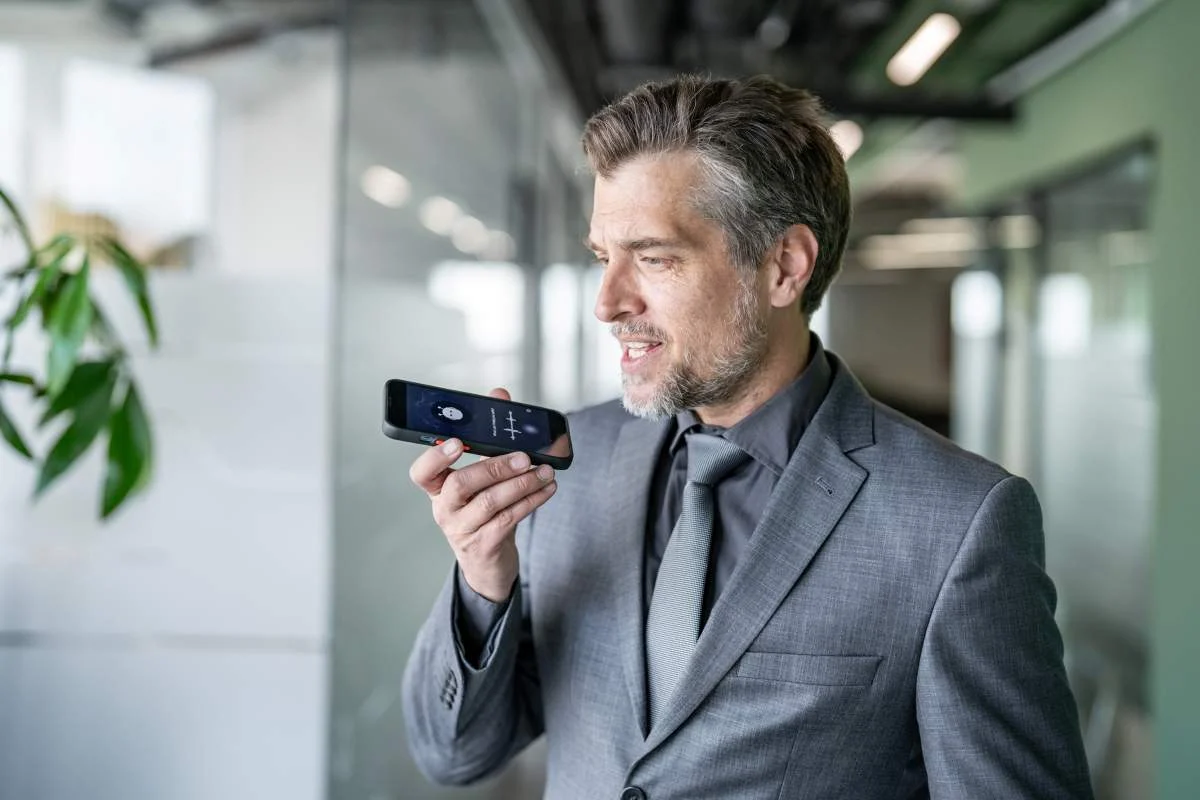 Man in suit dictating to his phone