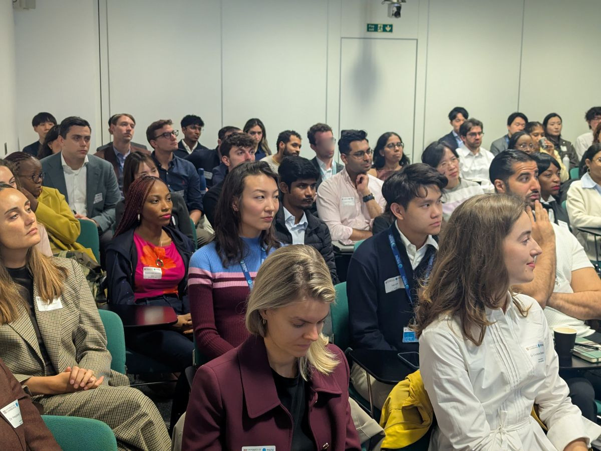 Masters students listening to a presentation